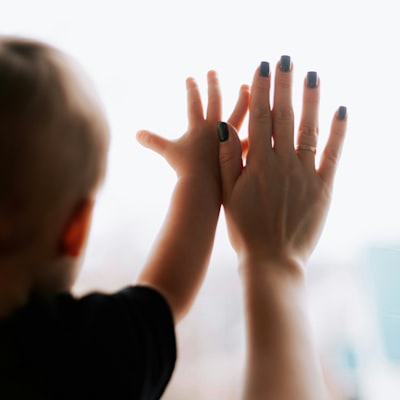 A child and parent sharing a high five